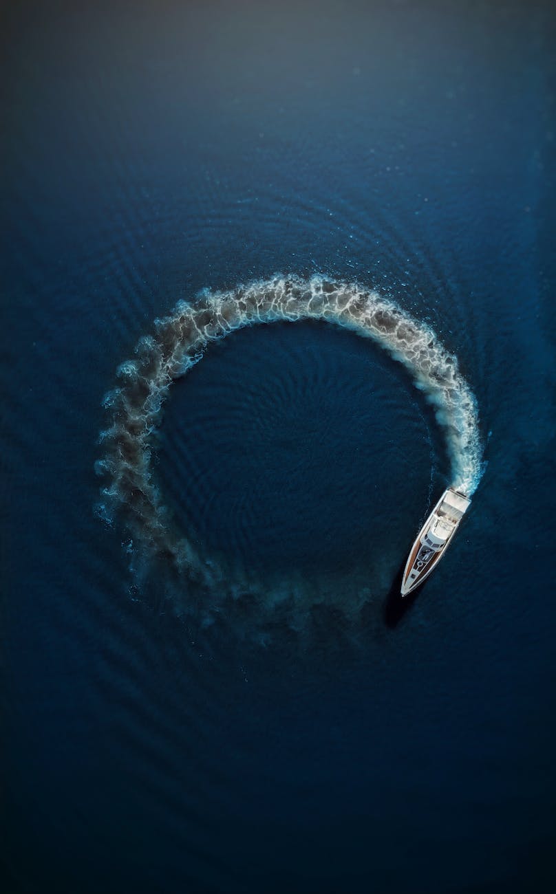 motor boat making circle on water surface
